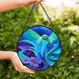 Round glass fairy suncatcher in a black frame and a hanging black chain featuring Lunaria Silvermist of the Fae Realm by Primal Painter. Blues, greens, and purples, and florals. 