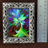 Decorative frame with a colorful fairy design next to a ruler for size reference.