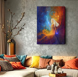 Vivid goddess art canvas print by Primal Painter called Nebula in hot reds, warm oranges and celestial blue with stars. Hanging over a couch with colorful pillows