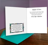 Open card with text and decorative elements on a wooden surface with a purple background
