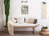 Abstract art canvas print called by Pele by Primal Painter featuring the Hawaiian goddess in pastel earth tones. Hanging over a couch