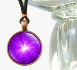 handmade chakra necklace featuring a bright purple starburst art print sealed under glass and representing the third eye chakra