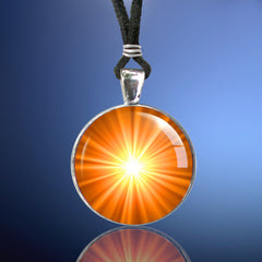 Handmade chakra necklace featuring a bright orange starburst art print by Primal Painter representing the sacral chakra and sealed under a glass dome