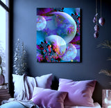Spirit Orbs by Primal Painter is a canvas print in blues, violets, and fuchsia with intricate fractal designs inside translucent orbs. Hanging over a bed on a blue gray wall