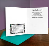 Open card with text and decorative elements on a wooden surface with a purple background