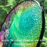 Side view of a glass suncatcher showing the texture of the glass. 