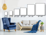Living room with blue armchair, sofa, and various wall art frame sizes displayed.