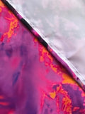Close-up of a fabric with pink and orange abstract pattern on a white background