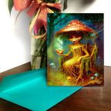 Greeting card with a mushroom character holding a cup, placed on a table with a blue envelope.