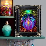 Original digital art of a sphere encircling the violet flame and surrounded by fairies with an intricate rainbow colored pattern in the background. Reiki-inspired art for energy workers and spiritual seekers in a black frame on a bohemian shelf