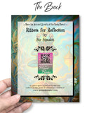 Card with 'Ribbets for Reflection' by Sir Sipsalot and QR code held by a hand against a colorful background.