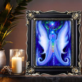 Two white and blue twin flame angels stand face to face, the full spectrum of chakra colors aligned between them, a starburst blazing above their heads and twin moons grounding them at the base. Art print called Twin Souls  by Primal Painter. Framed on a shelf with candles