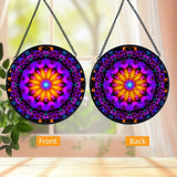 Back and front views: Textured glass mandala suncatcher featuring violet flame mandala artwork by Primal Painter in vivid purple, reds and orange. 