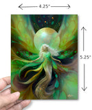 A hand holds a vertical art story card  showing a fantasy fairywith flowing green, yellow, and dark maroon abstract wings and a glowing circular backdrop. Size dimensions