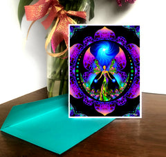 A greeting card with a colorful mandala design and an angel motif, with a glossy finish and a white border on the sides. The card is displayed in front of a teal background and is accompanied by a brightly colored envelope. by Primal Painter