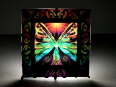 nightlight featuring butterfly fairy wings in rainbow colors with a victorian black frame as a silhouette. Art by Primal Painter