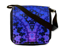 A black messenger bag with a purple and indigo blue abstract art flap featuring a geometric pattern. Art by Primal Painter