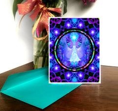 A greeting card with a colorful mandala-themed design featuring an angel, placed on a greeting card organizer with a brightly colored envelope by Primal Painter