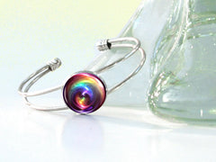 Silver wire cuff bracelet featuring chakra swirl rainbow artwork under a glass dome by Primal  Painter