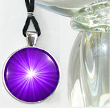 Purple starbust art necklace in a silver finished setting with third eye chakra symbolism 