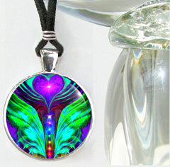 angel wings with the chakra colors in the center displayed as a round necklace under a glass dome by Primal Painter