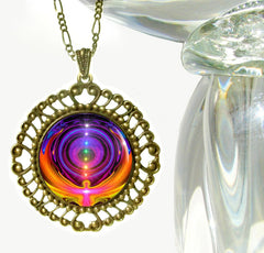 A colorful rainbow chakra necklace with a bronze-finished setting and a soldered link chain by Primal Painter.