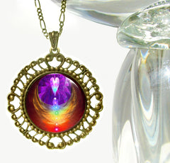 Rainbow chakra angel art shown in a large bronze pendant under glass by Primal Painter