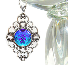 diamond shaped lacy filligree necklace featuring a purple and teal geometric abstract art print by Primal Painter and sealed under glass