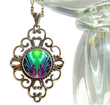 diamond shaped necklace featuring geometric green and purple abstract art