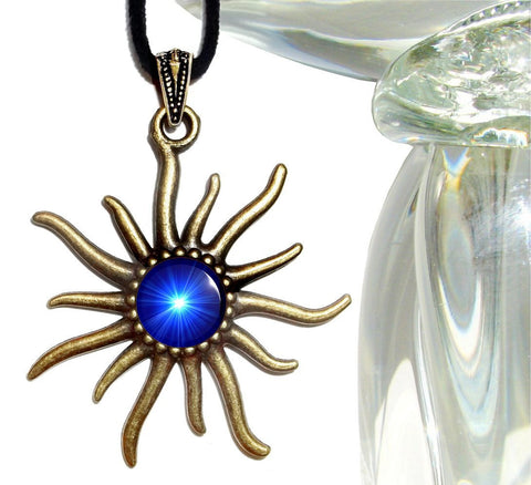 bronze sun shaped necklace with an embellished bail and featuring bright blue starburst artwork representing the throat chakra and set under a glass dome