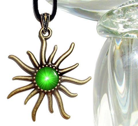 bronze sun shaped necklace with an embellished bail and featuring bright green starburst artwork set under a glass dome