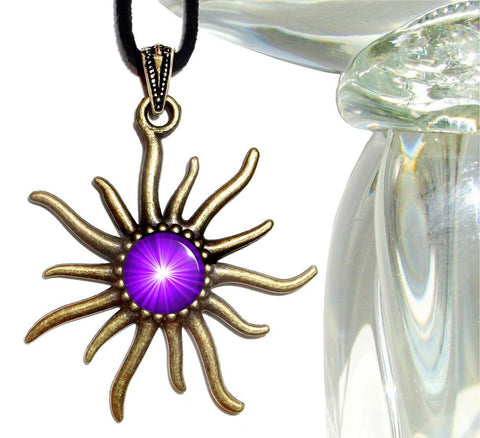 sun shaped bronze pendant with an embellished bail and featuring a bright purple chakra sunburst representing the third eye and sealed under a glass dome