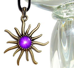 sun shaped bronze pendant with an embellished bail and featuring a bright purple chakra sunburst representing the third eye and sealed under a glass dome by Primal Painter