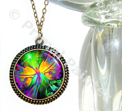 A round bronze necklace featuring a rainbow colored art print by Primal painter of a luminous fairy with rainbow wings. 