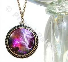 A colorful eye-catching pendant with a space-themed design, featuring a double row of dots around the edge and a central artwork depicting a swirl of vibrant colors with a guardian angel by Primal Painter, presented on a bronze-finished chain.