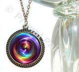 Large bronze necklace with a swirl of rainbow chakra colors artwork sealed under glass