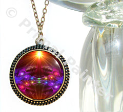 chakra art by Primal Painter as a round necklace under a glass dome. 
