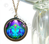 Bronze necklace featuring twin flames artwork by Primal Painter in blue, teal, and purple and sealed under glass