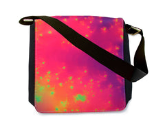 A black messenger bag with a snap-on abstract art flap featuring a vibrant, multicolored abstract pattern with yellow sparkles, and a smooth, satiny texture. Art  by Primal Painter