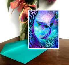 A greeting card featuring a colorful fantasy art design with a fairy angel motif, titled 'The Divine Light', with a white border and a blank interior for personal message. Art by Primal painter