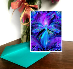 A greeting card featuring abstract purple and blue angel art with a matte surface on the inside for writing, placed on a teal envelope. Art by Primal Painter