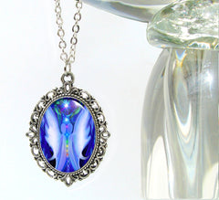 Oval Silver necklace with twin flame angels in blue and white attached by their chakras between them by Primal Painter